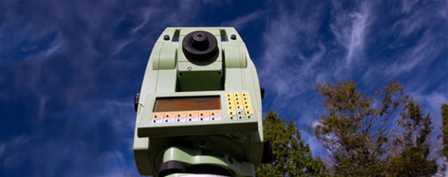 Surveying equipment pictured against a blue sky